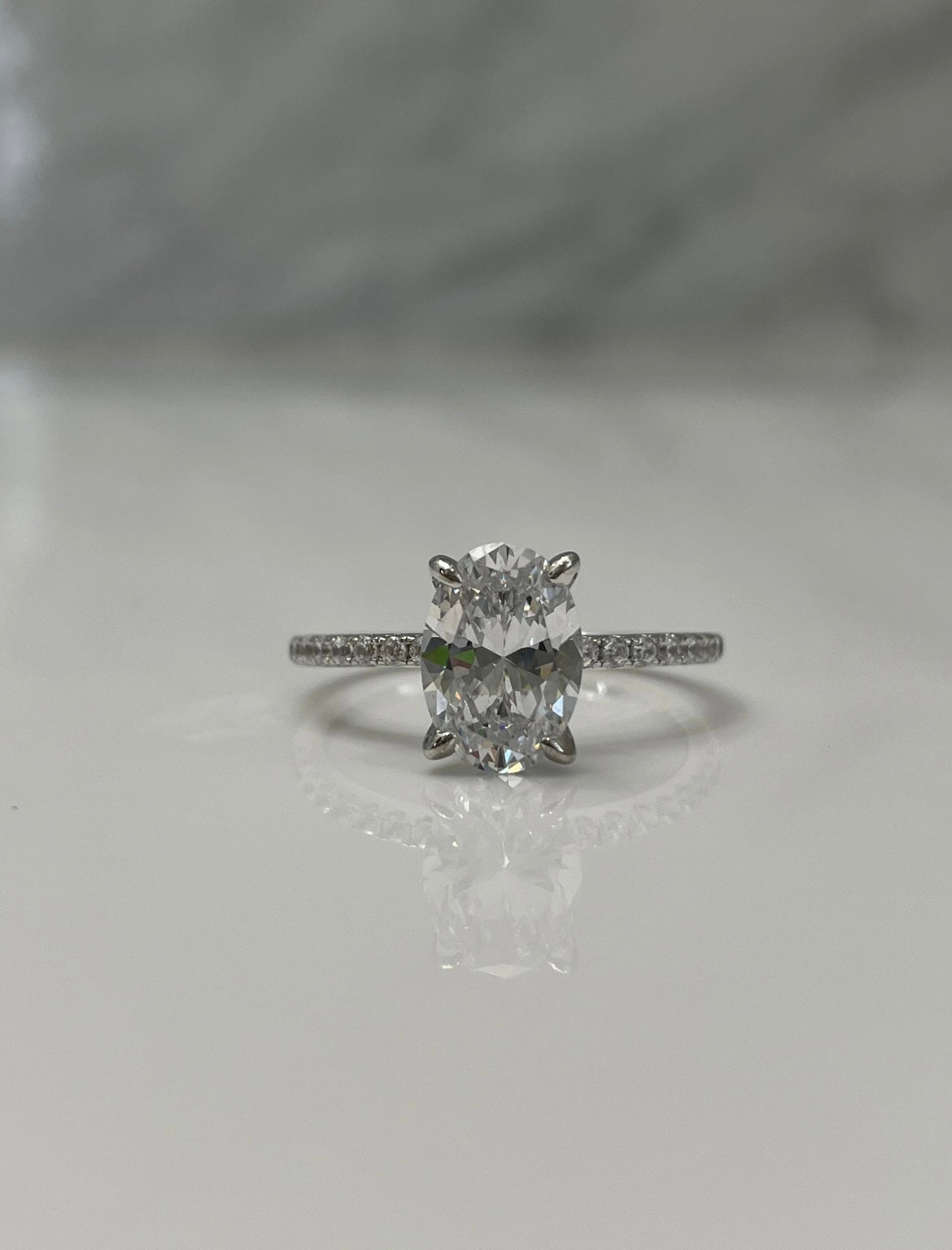 Hidden Halo. Sterling Silver 925 engagement ring with 2.2CT oval cut simulated diamond and hidden halo