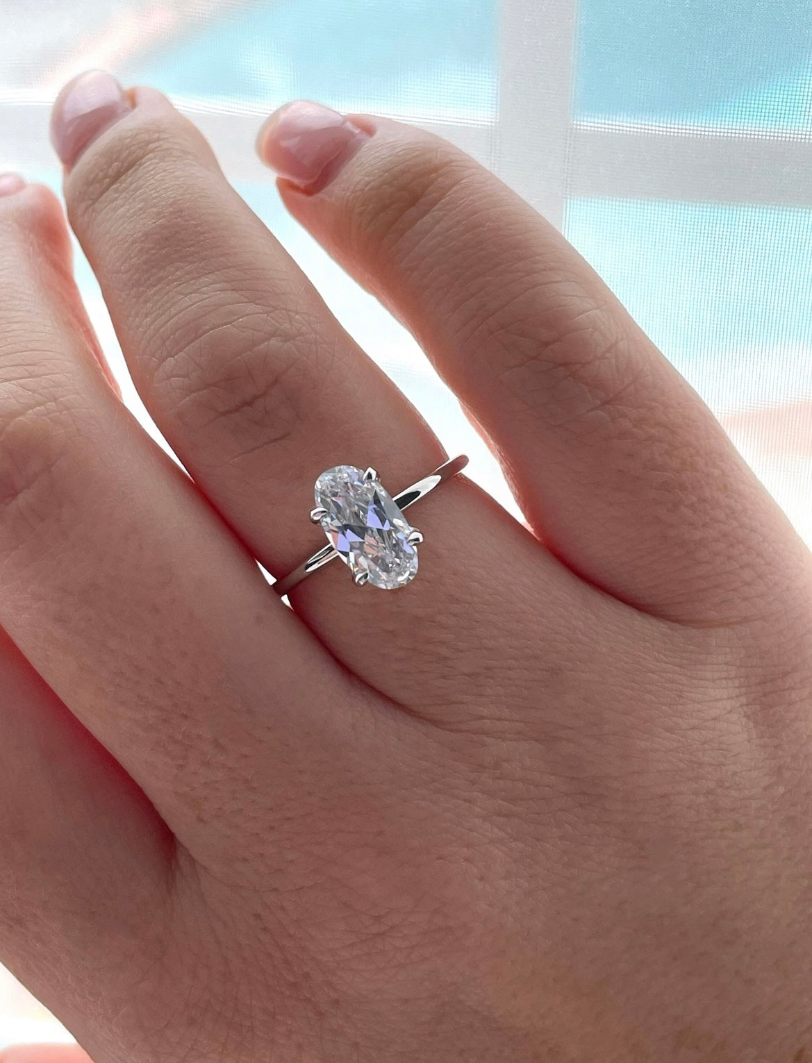 The Chelsea. Yellow gold vermeil, rose gold vermeil, white gold vermeil engagement ring with 2.5CT elongated oval cut simulated diamond.