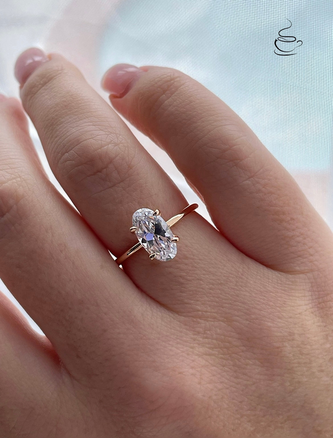 The Chelsea. Yellow gold vermeil, rose gold vermeil, white gold vermeil engagement ring with 2.5CT elongated oval cut simulated diamond.