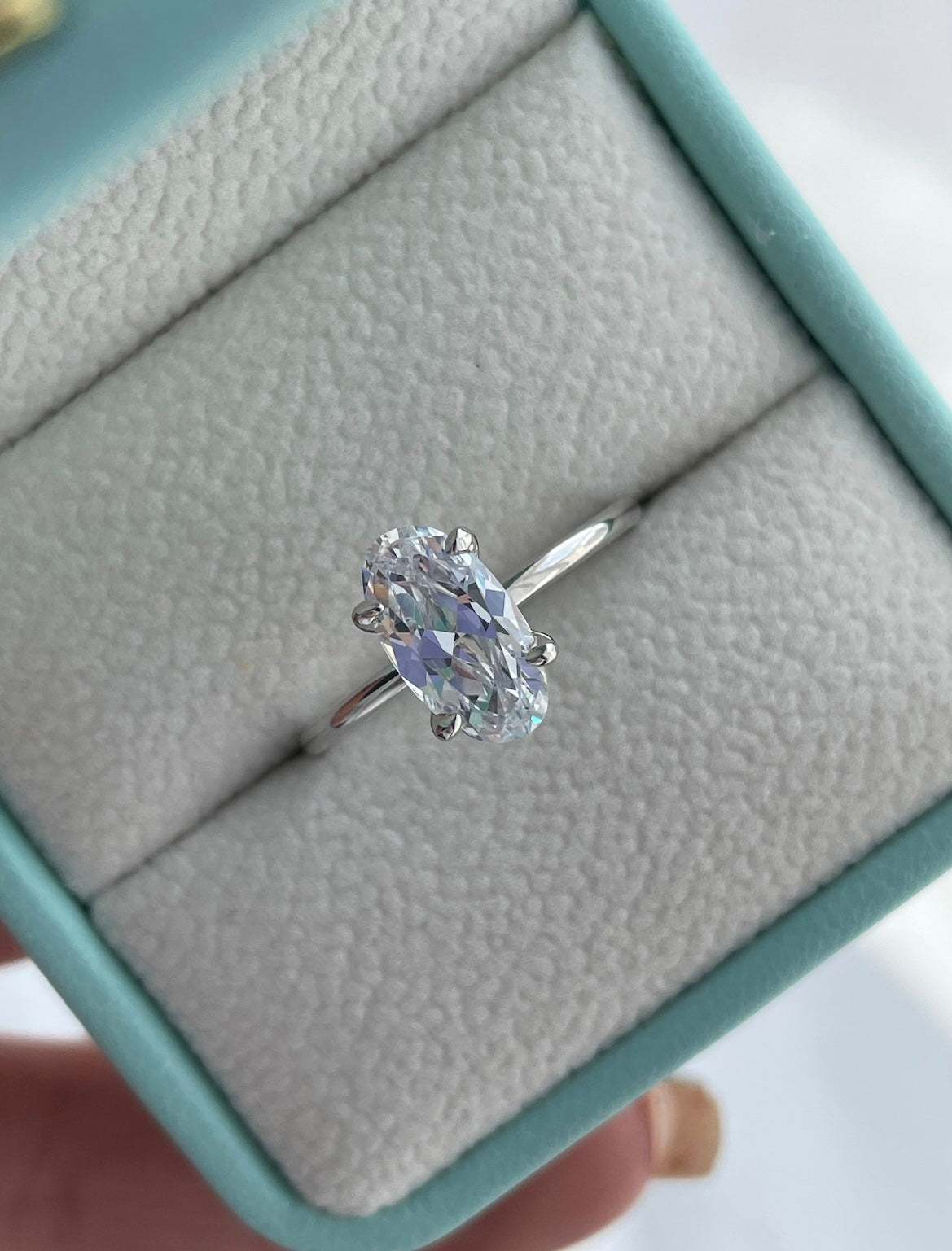 The Chelsea. Yellow gold vermeil, rose gold vermeil, white gold vermeil engagement ring with 2.5CT elongated oval cut simulated diamond.