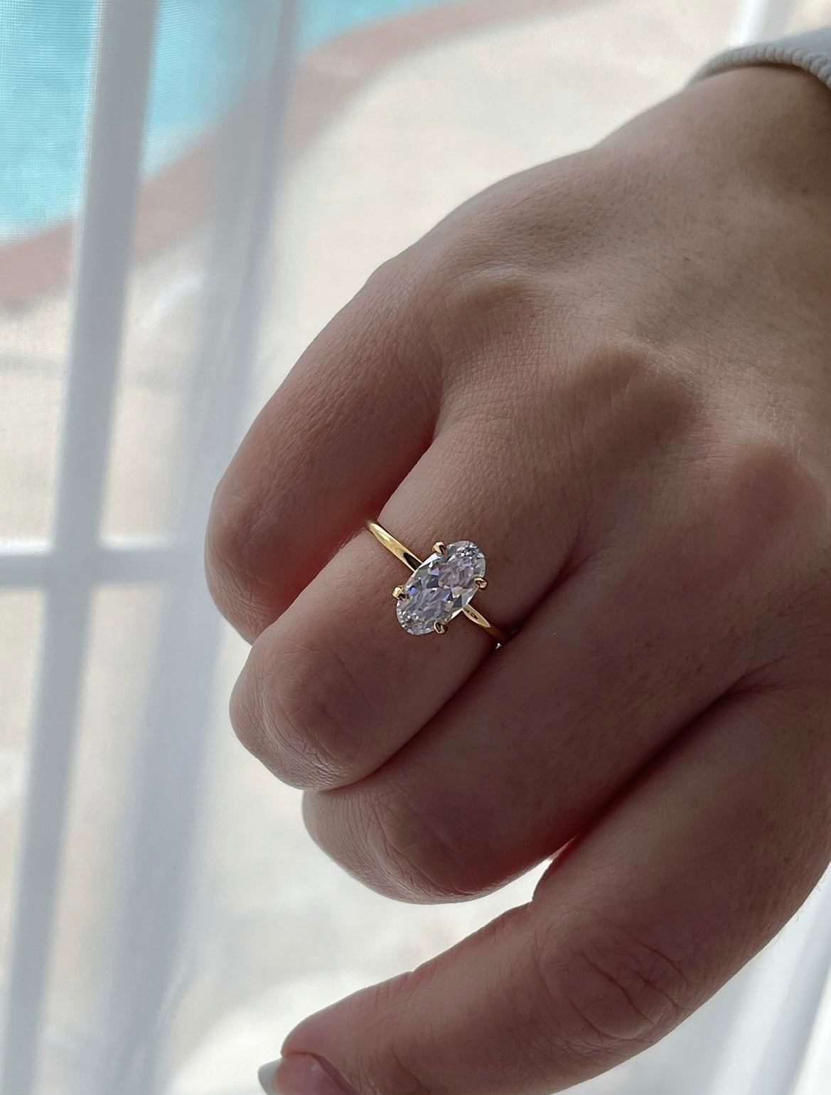 The Chelsea. Yellow gold vermeil, rose gold vermeil, white gold vermeil engagement ring with 2.5CT elongated oval cut simulated diamond.