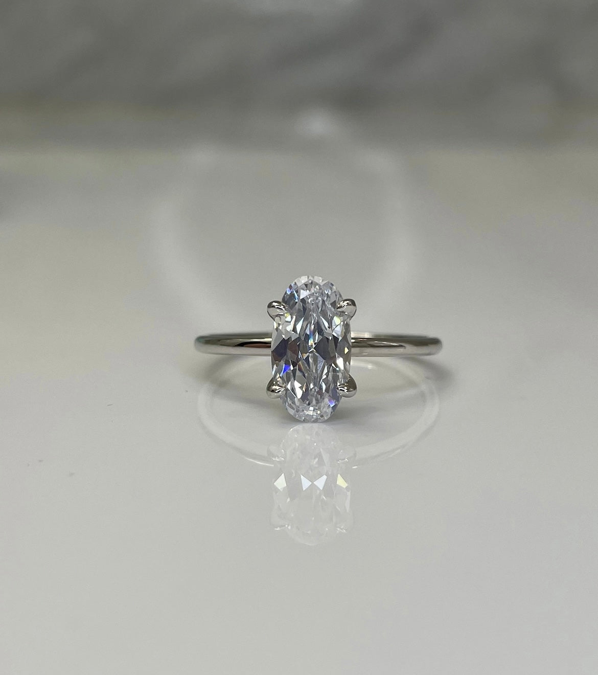 The Chelsea. Yellow gold vermeil, rose gold vermeil, white gold vermeil engagement ring with 2.5CT elongated oval cut simulated diamond.
