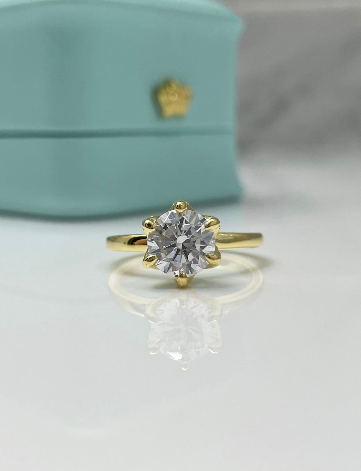 The Bella. Sterling Silver 925, yellow gold vermeil engagement ring with 2CT round brilliant cut simulated diamond.