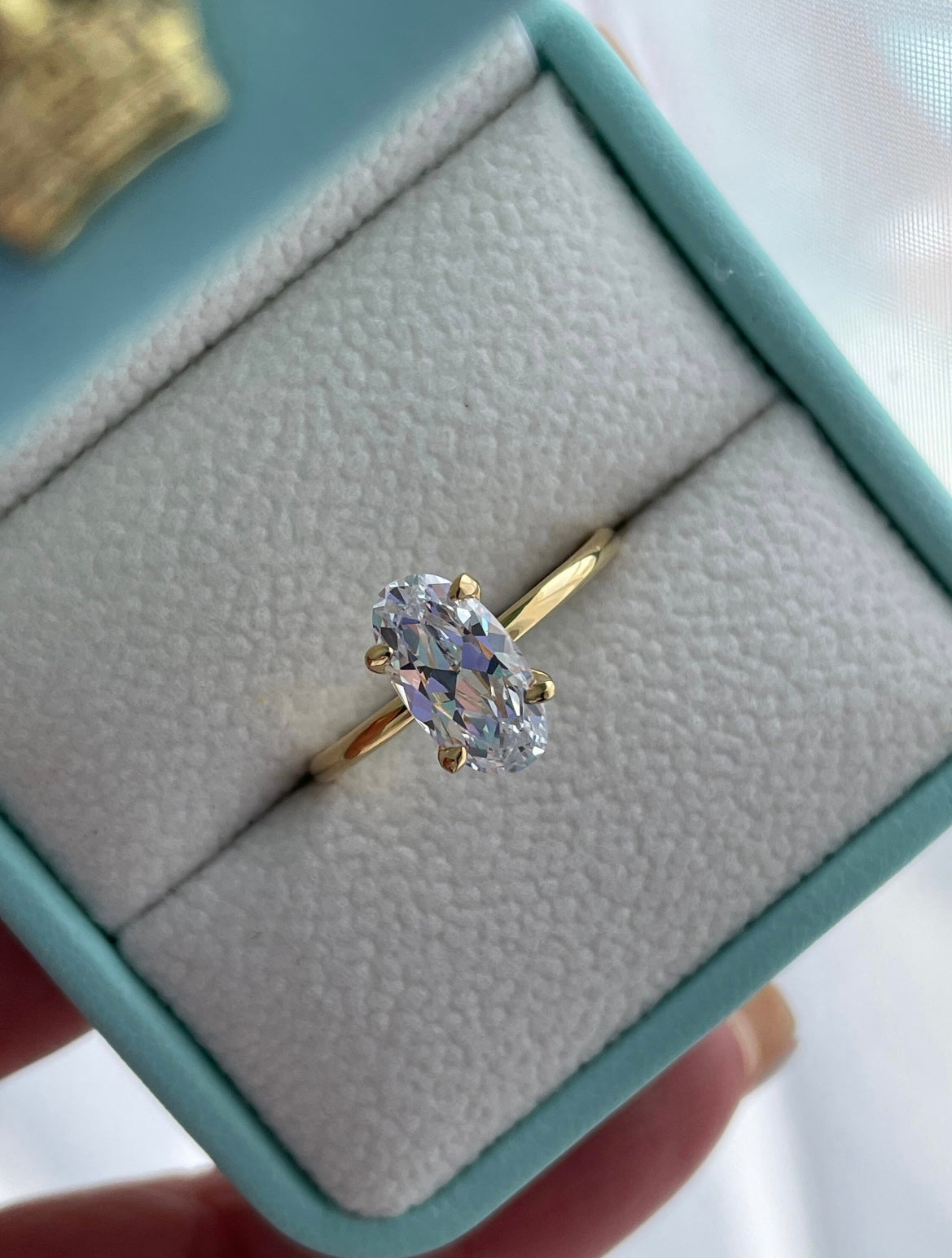 The Chelsea. Yellow gold vermeil, rose gold vermeil, white gold vermeil engagement ring with 2.5CT elongated oval cut simulated diamond.