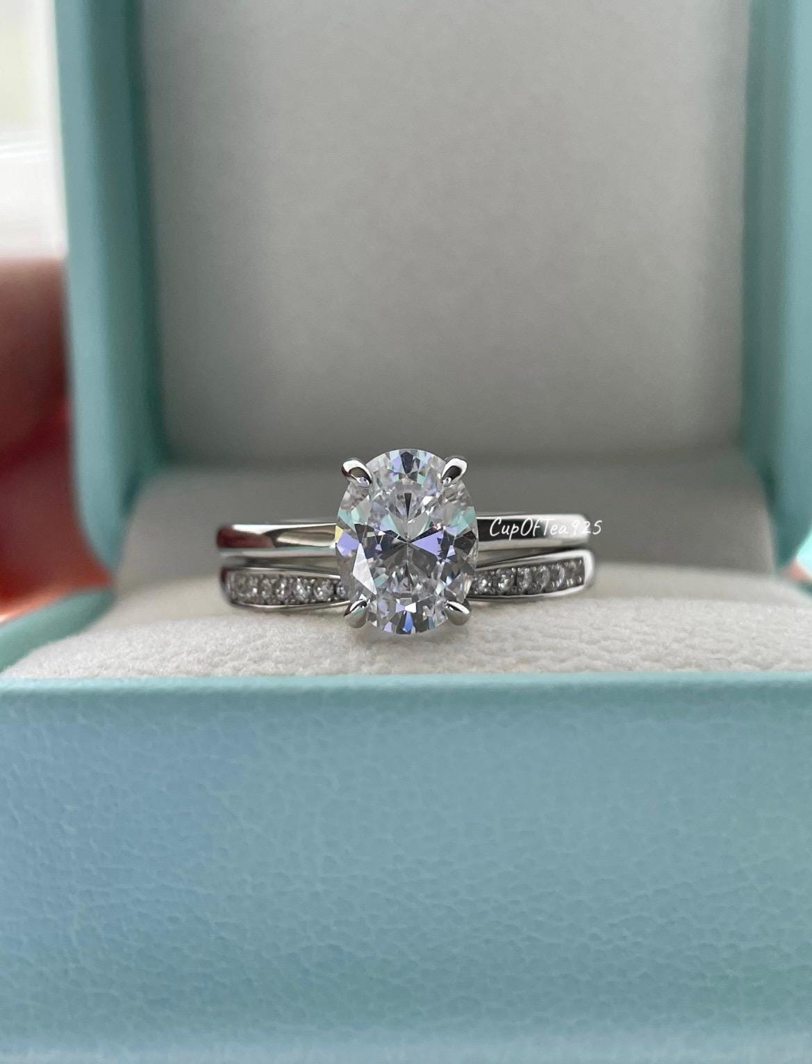 14K white gold bridal set with 2CT oval cut moissanite and curved moisanite band.