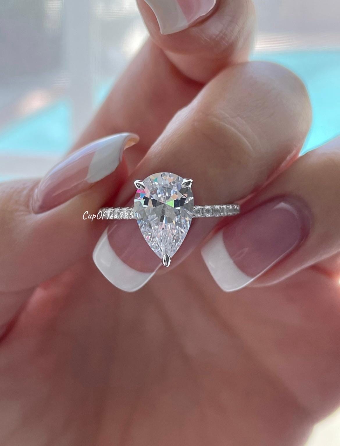 Pear cut ring with hidden halo. Sterling Silver 925 engagement ring with 3CT pear shaped simulated diamond and hidden halo.