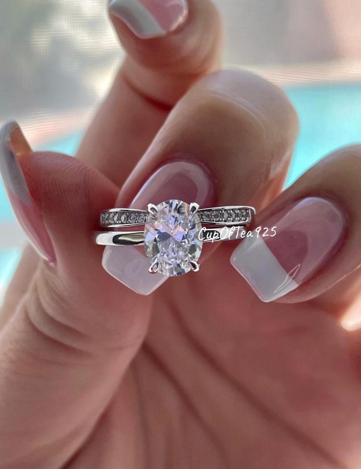 14K white gold bridal set with 2CT oval cut moissanite and curved moisanite band.