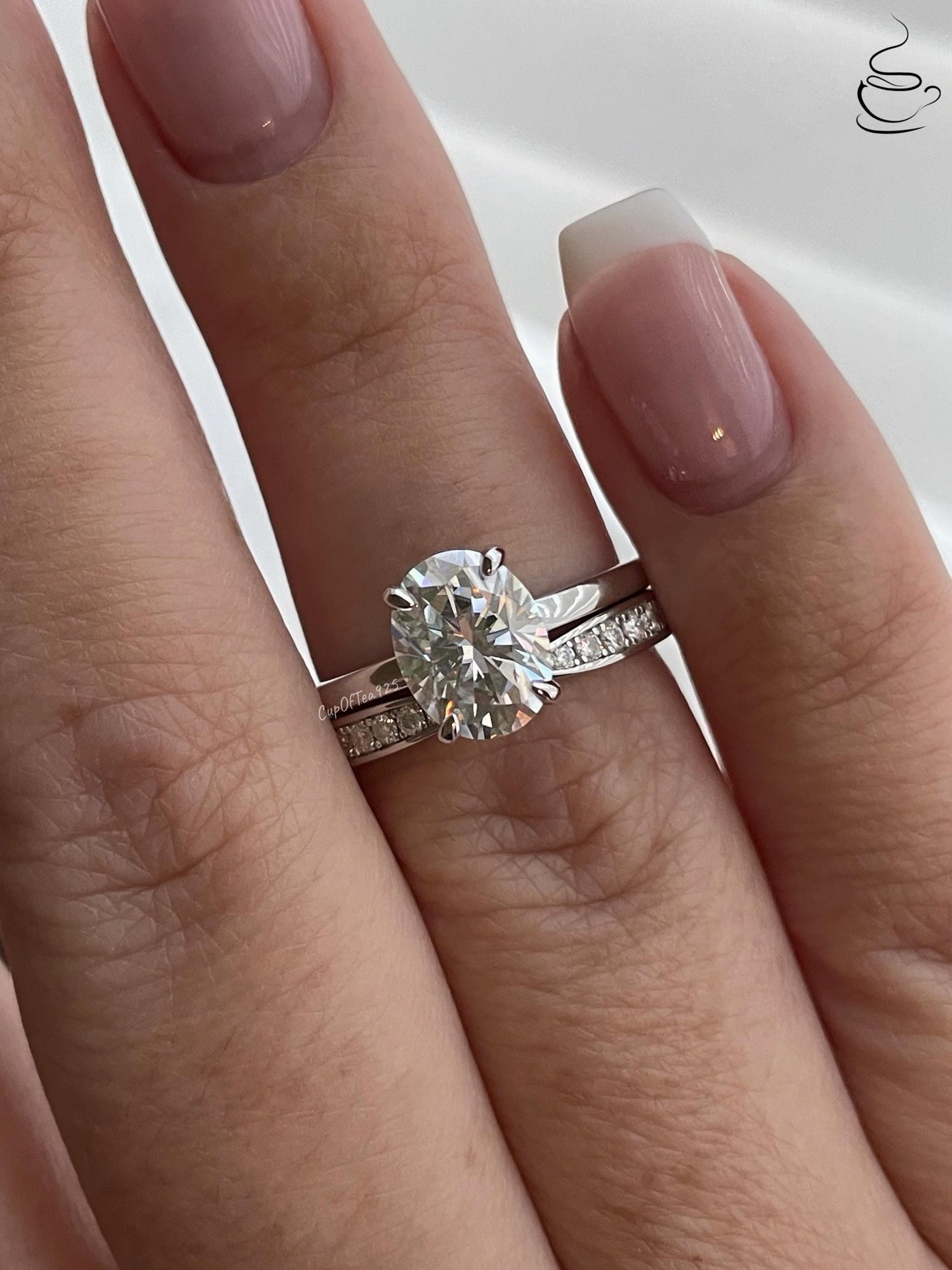14K white gold bridal set with 2CT oval cut moissanite and curved moisanite band.