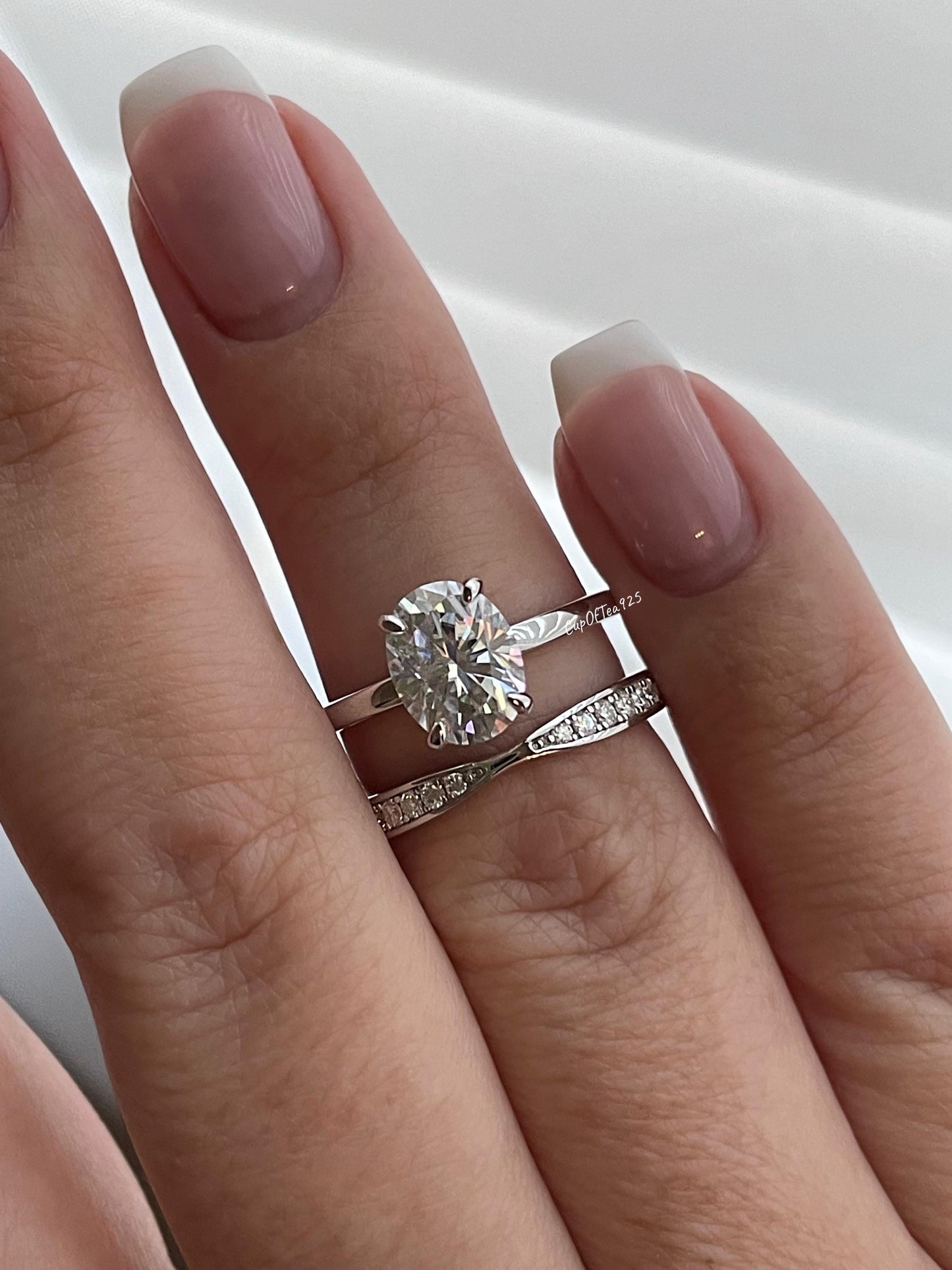 14K white gold bridal set with 2CT oval cut moissanite and curved moisanite band.