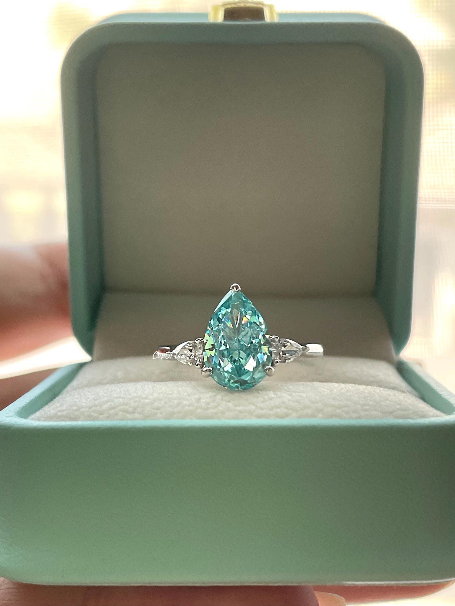 3 carat pear shaped engagement ring with blue crushed ice aquamarine simulated diamond in sterling silver or yellow gold vermeil