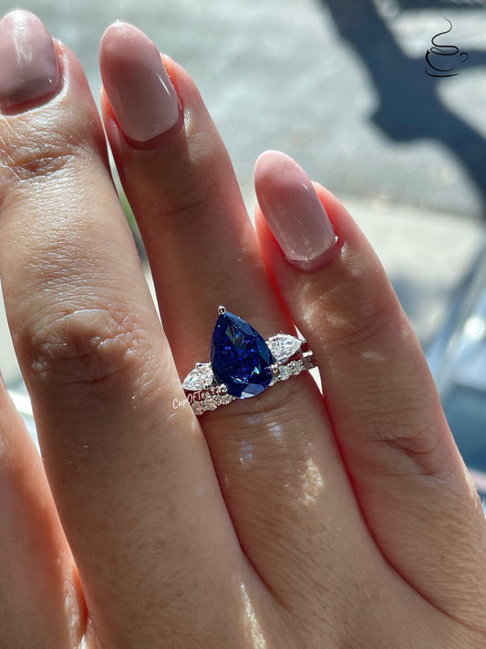 There stone engagement ring with pear cut crushed ice blue sapphire and moissanite half eternity band, September birthstone ring