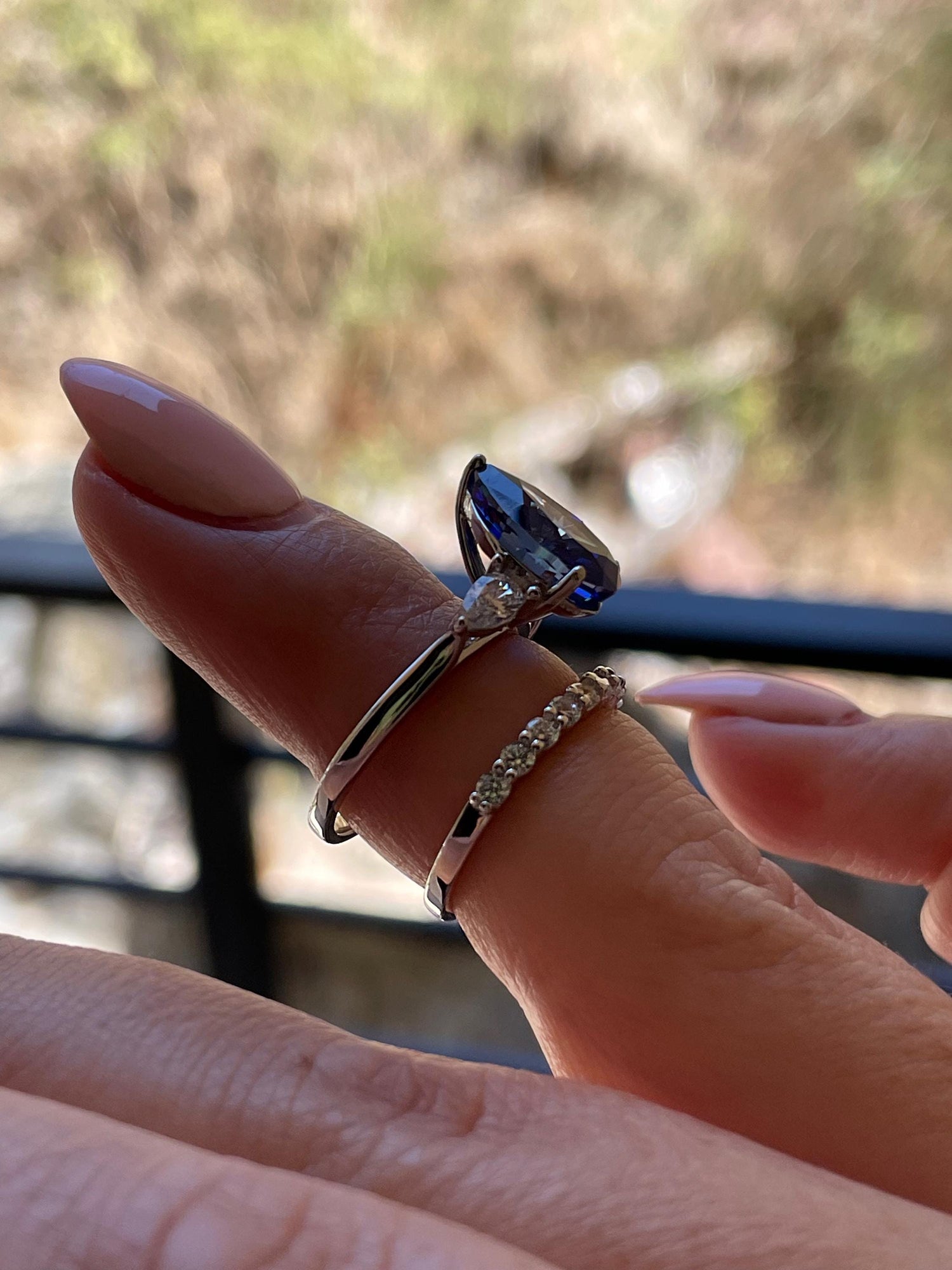 There stone engagement ring with pear cut crushed ice blue sapphire and moissanite half eternity band, September birthstone ring