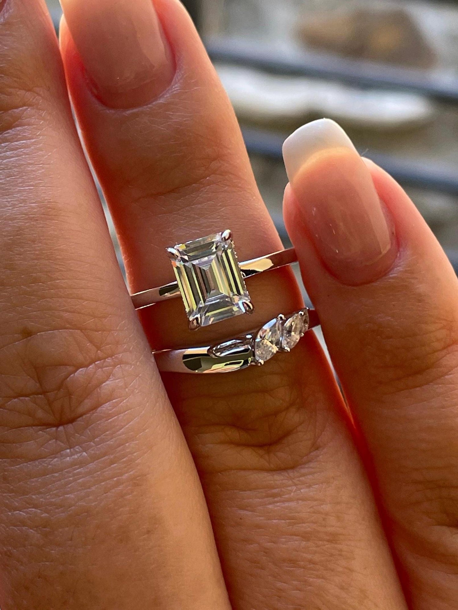 2 carat emerald cut moissanite engagement ring set. Sterling silver 925 bridal ring set with 2CT solitare with hidden halo and curved band.