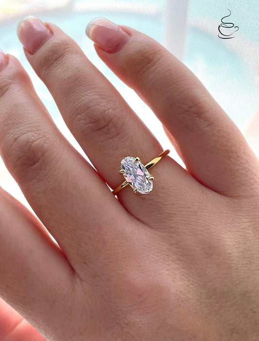 The Chelsea. Yellow gold vermeil, rose gold vermeil, white gold vermeil engagement ring with 2.5CT elongated oval cut simulated diamond.
