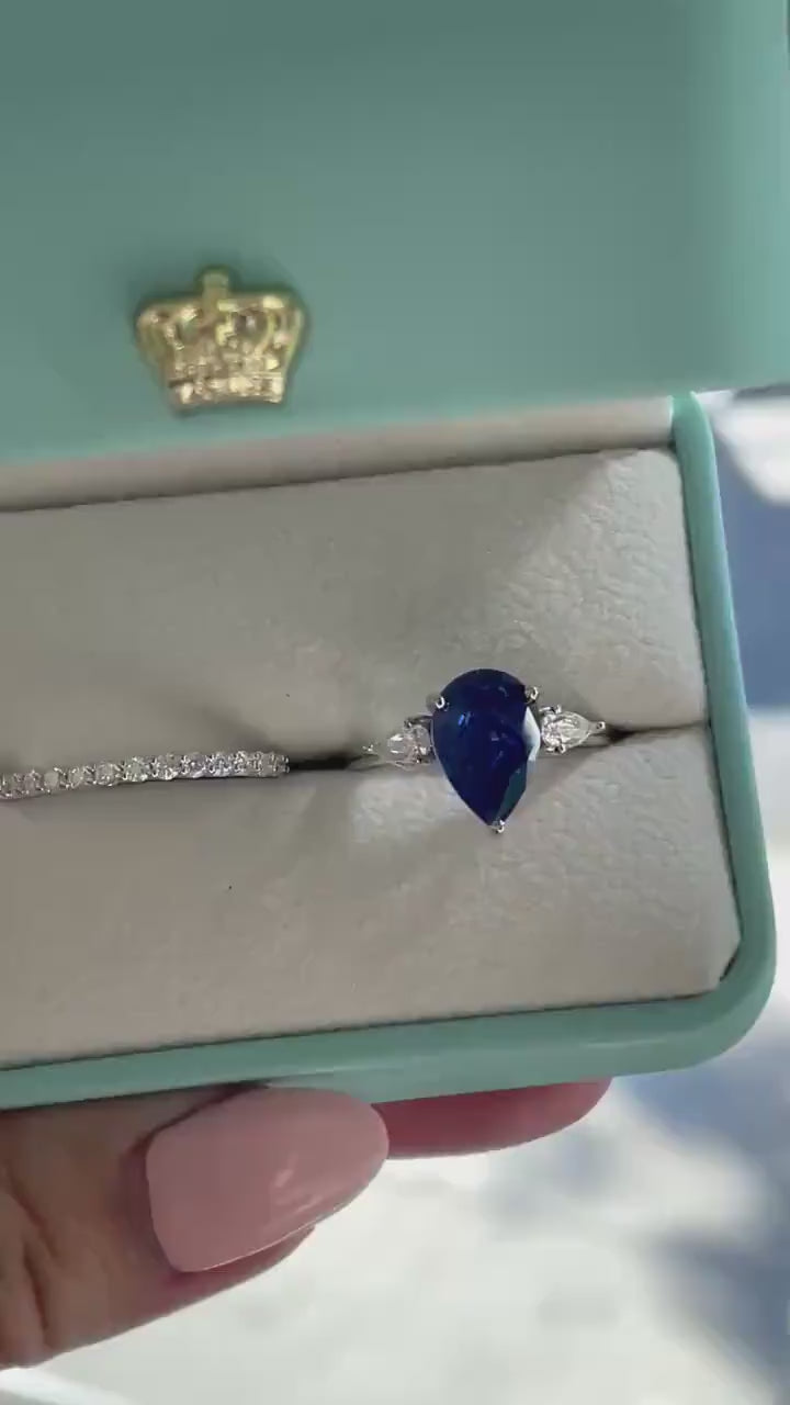 There stone engagement ring with pear cut crushed ice blue sapphire and moissanite half eternity band, September birthstone ring